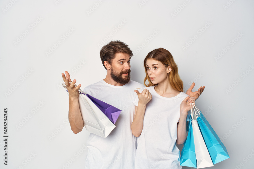 young couple in t-shirts shopping discount sale fun young couple in t-shirts shopping discount sale fun