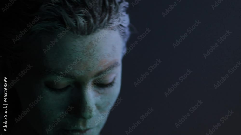 Mystical woman with embossed make-up image of a mermaid siren in neon light. Video noise and soft focus. Mystical woman with embossed make-up image of a mermaid siren in neon light. Video noise and soft focus.