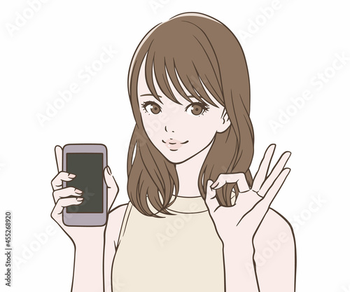 スマートフォンを持ち、OKマークをつくる女性