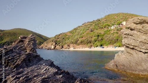 4k drone flight back footage (Ultra High Definition) of Kama beach in Kalamos village. Camp side on Euboea island, Greece, Europe. Sunny summer seascape of Aegean sea.. photo