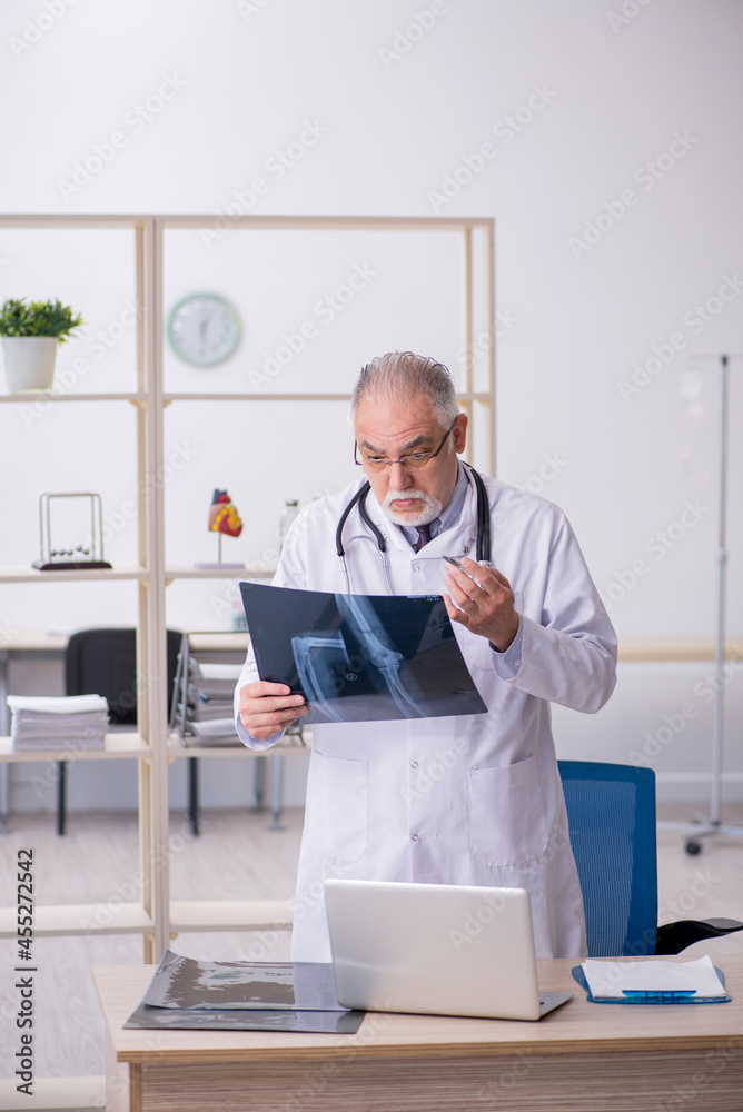 Old male doctor radiologist working in the clinic Old male doctor radiologist working in the clinic