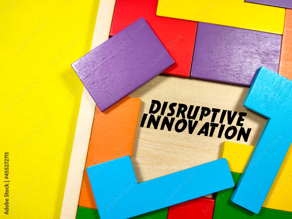 Business Concept.Text DISRUPTIVE INNOVATION writing on wooden puzzle on a yellow background. Business Concept.Text DISRUPTIVE INNOVATION writing on wooden puzzle on a yellow background.
