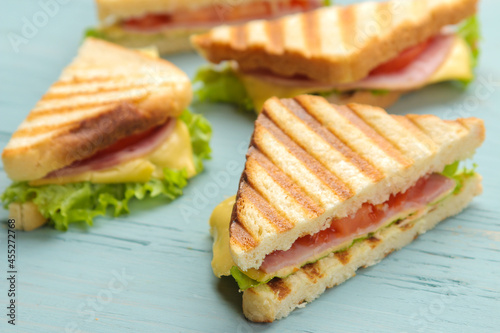 Close-up sandwich with ham cheese and tomato on blue background