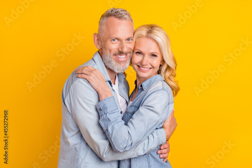 Photo of cheerful positive old wife husband hug embrace smile good mood enjoy isolated on yellow color background