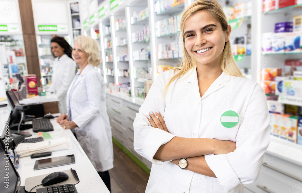 Portrait of young female pharmacist in drugstore.