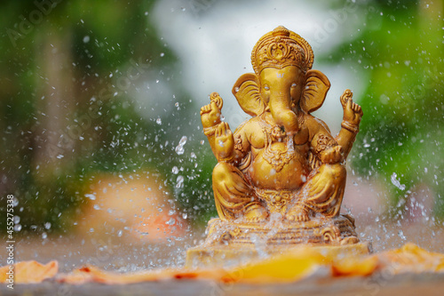 Water splash on lord ganesha sculpture. celebrate lord ganesha festival.