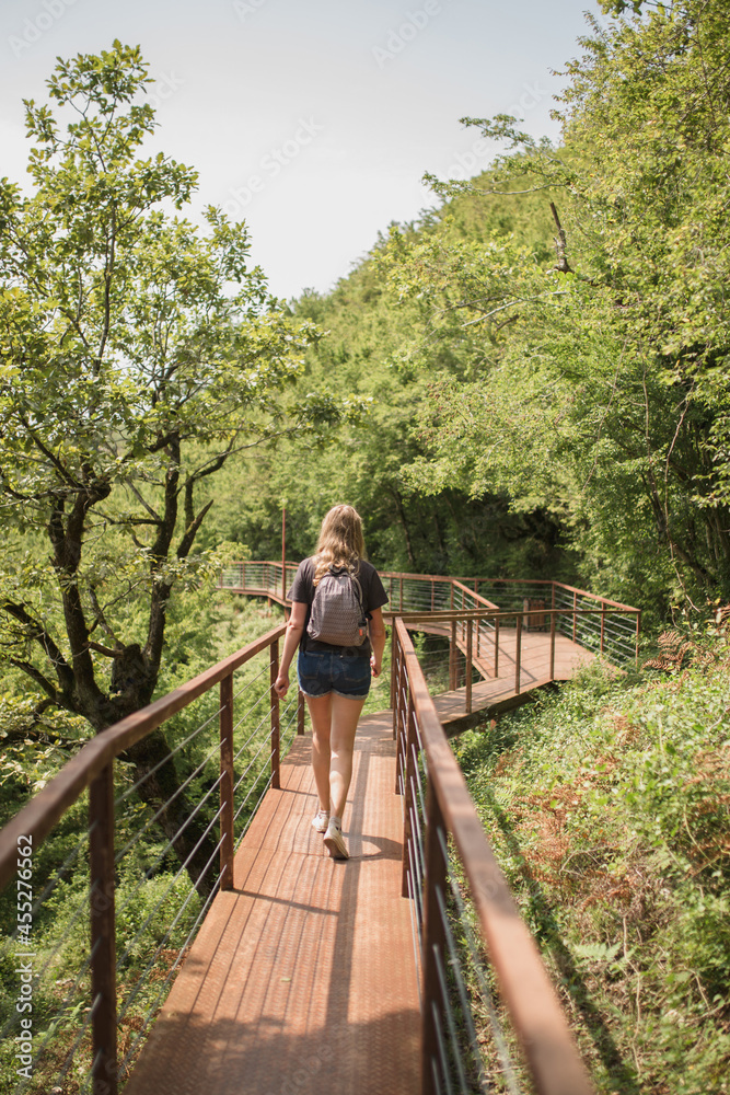 walking on a suspension bridge in the Okatse canyon at an altitude of 140 meters above the bottom of the gorge
