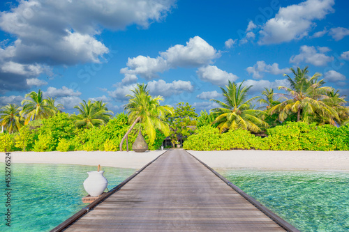 Fototapeta Naklejka Na Ścianę i Meble -  Idyllic tropical beach landscape for background or wallpaper. Design of tourism for summer vacation holiday destination. Maldives island beach panorama. Palm trees and beach bar and long wooden pier