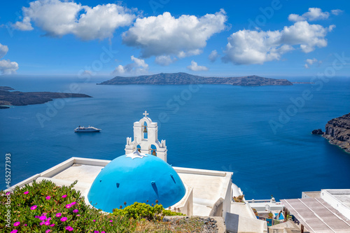 Relaxing and romantic view with white architecture in Santorini Greece, caldera view over blue sea and volcano island. Summer landscape for travelling and vacation template. Luxury resort hotel famous