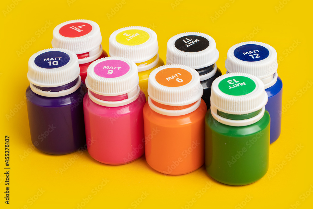Color oil paint bottles on yellow background Color oil paint bottles on yellow background