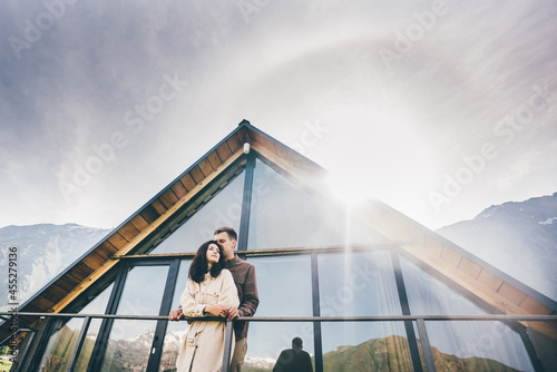 Happy couple sitting in a cozy home with a mountain view.