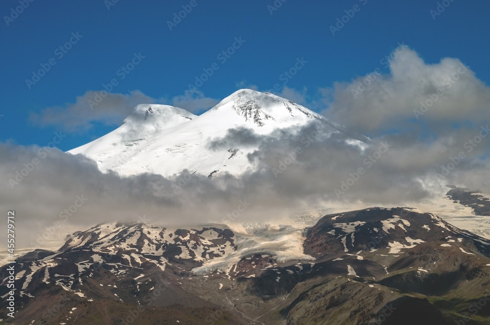 The Caucasian mountain Range. Perspective of caucasian snow mountain or volcano Elbrus. Landscape view - the highest peak of Europe