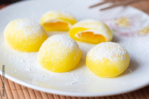 Mochi on a white plate. Yellow rice dessert, mochi is mostly Japanese traditional sweet food photo