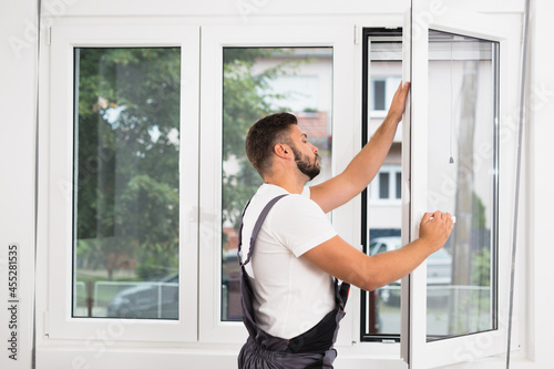 Fotografija worker fixing pvc windows indoor