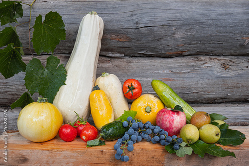 Autumn harvest after rain on woody background