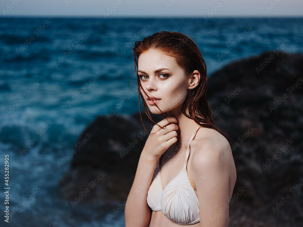 pretty woman in white swimsuit posing rock luxury pretty woman in white swimsuit posing rock luxury