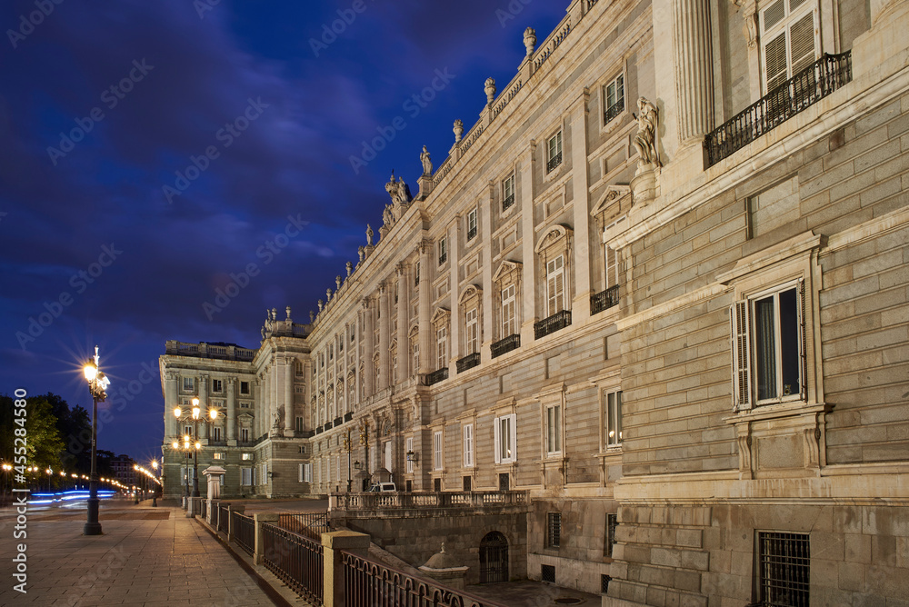 Principal facade of the Royal Palace (Palacio Real) of Madrid at nightfall. View from Plaza de Oriente Square. Madrid, Spain.