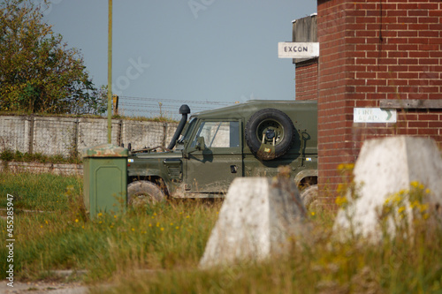 Valokuvatapetti a british army Land Rover Defender light utility military vehicle parked in a co