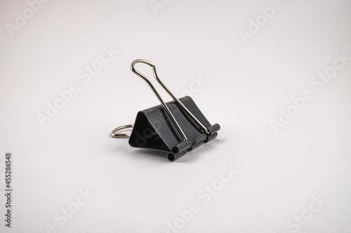 Black metal clip on a white background