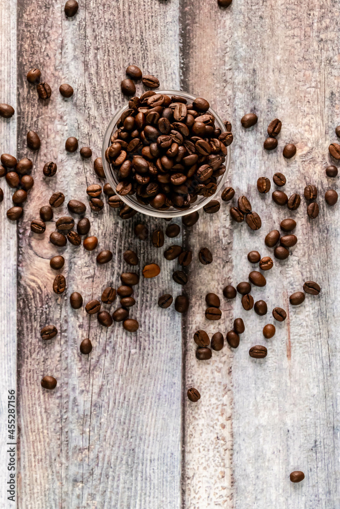 Top shot of coffee beans in glass bowl with portrait orientation and copy space. Top shot of coffee beans in glass bowl with portrait orientation and copy space.