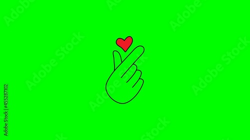 animation finger with a heart icon. Korean heart love sign. hand holding a heart sign  valentine's day video 4k on white and green background