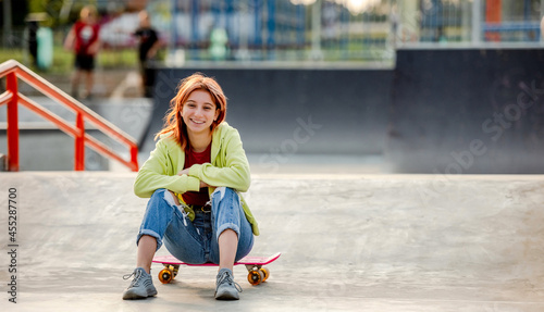 Girl with skateboard outdoors