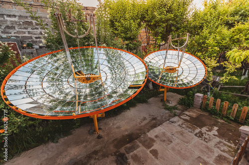 An amateur parabolic dish with pieces of a mirrors that is able to concentrate and focus solar energy at one point photo