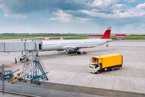 A ground service truck at the airport near an airline plane parked near the Gates. Delivery of food and drinks on board