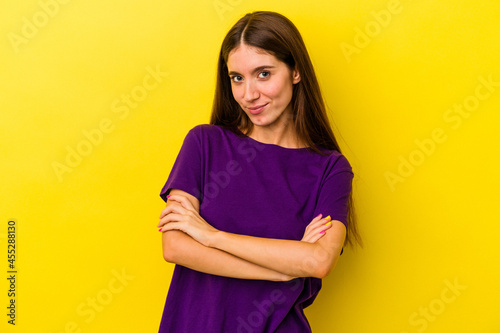 Young caucasian woman isolated on yellow background who is bored, fatigued and need a relax day. © Asier