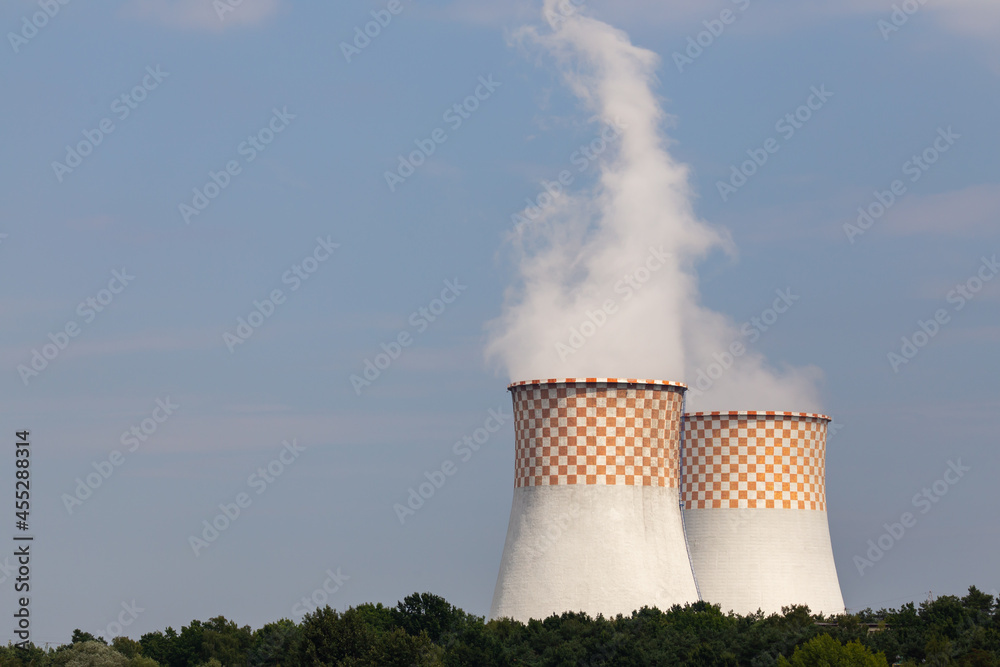 A close-up of the cooling towers of a coal-fired power plant. Photo taken on a sunny day with good lighting conditions.