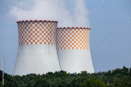 A close-up of the cooling towers of a coal-fired power plant. Photo taken on a sunny day with good lighting conditions.