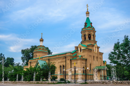 Facade of Cathedral of St. Alexy of Moscow in Samarkand, Uzbekistan. This rather unusual building for traditional East was built in 1912. Inscription on fence: 'Do not park cars in front of gate' photo
