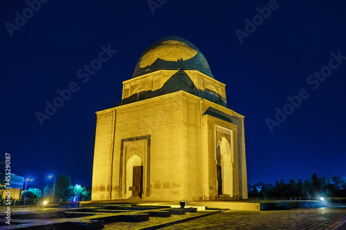 Rukhabad mausoleum illuminated at night, Samarkand, Uzbekistan. The building looks mystical and mysterious photo