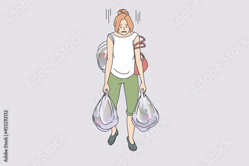 Carrying heavy bags tiredness concept. Young exhausted tired woman cartoon character going carrying many heavy shopping bags full of food from supermarket vector illustration 