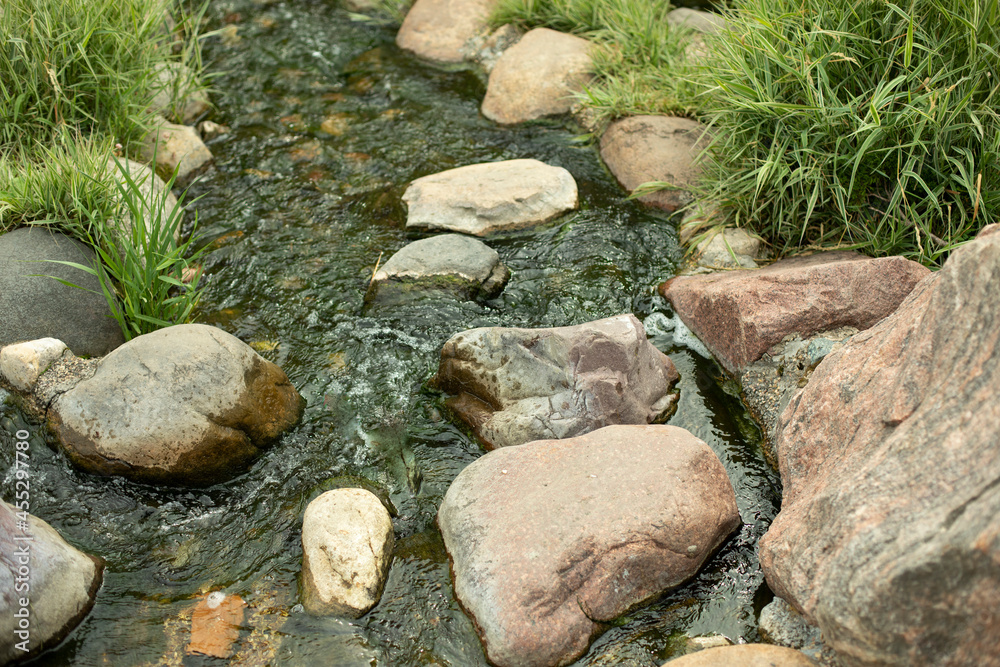 Water runs over the stones. Fresh water stream. Water runs over the stones. Fresh water stream.