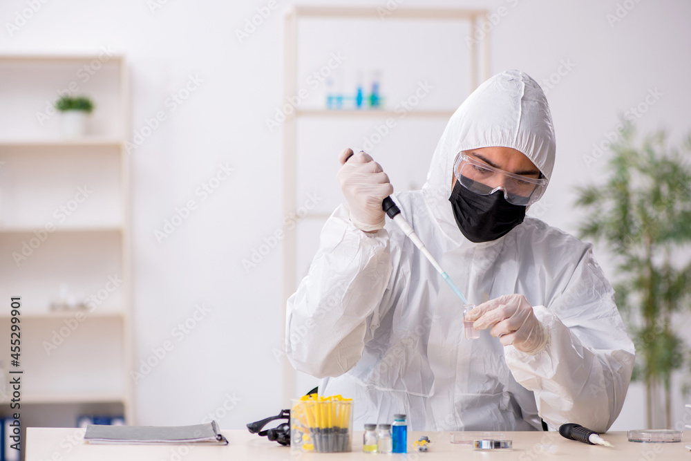 Young male chemist working at the lab during pandemic Young male chemist working at the lab during pandemic