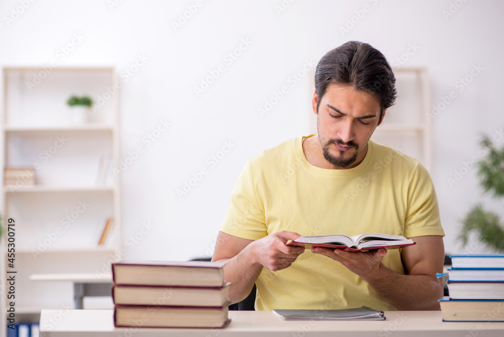 Young male student preparing for exams in the classroom Young male student preparing for exams in the classroom