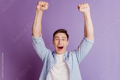 Quadro su tela Portrait of champion triumphant guy celebrate victory open mouth raise fists on