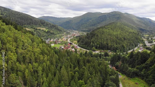 Beautiful village in the mountains from a height. Forest mountains and settlements. photo