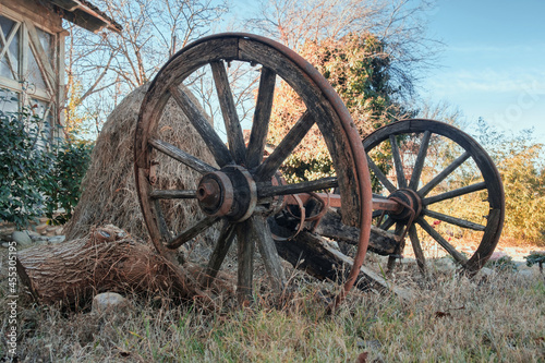 Old wooden horse cart carriage wheels at the farm yard