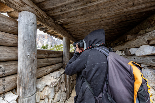 a tourist taking a picture of the trenches of the First World War. Dolomites, Cinque Torri, Nuvolau, Alps, Northern Italy