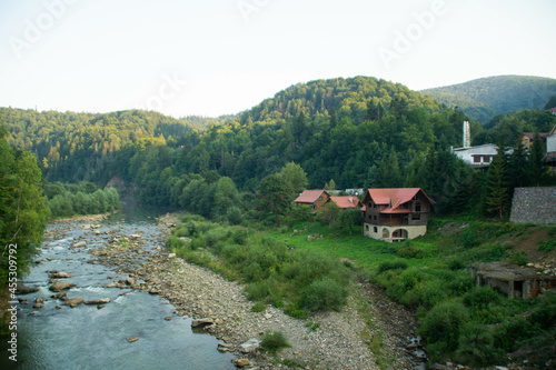 Yaremche, Ukraine - August 16th, 2021: Houses on Prut River photo