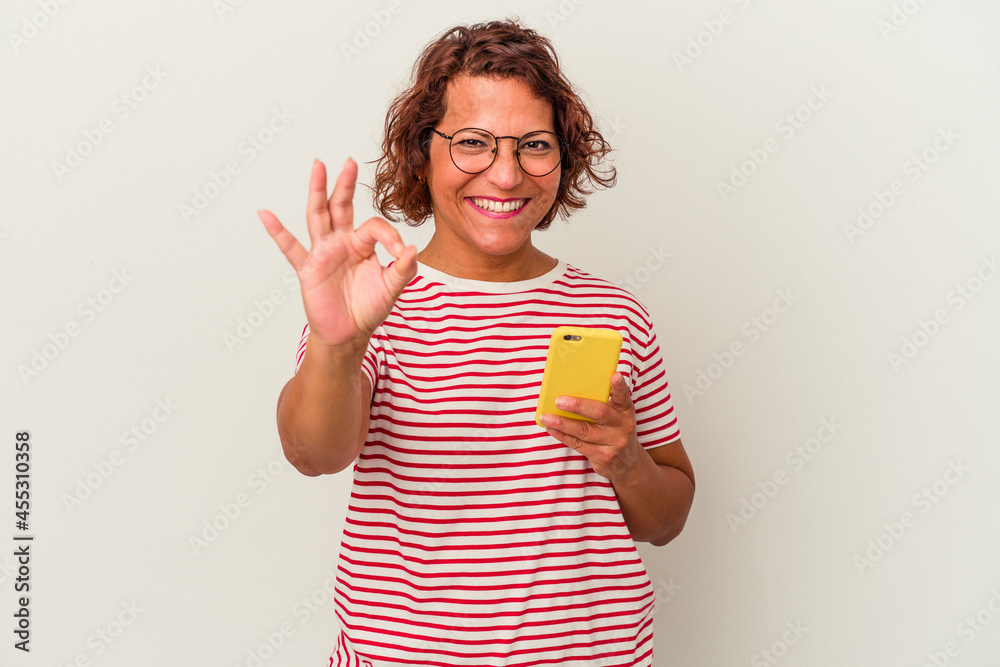 Middle age latin woman isolated on white background cheerful and confident showing ok gesture. Middle age latin woman isolated on white background cheerful and confident showing ok gesture.