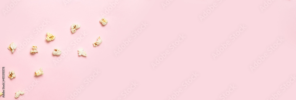 Salted popcorn on a pink background. Top view with copy space. Flat lay