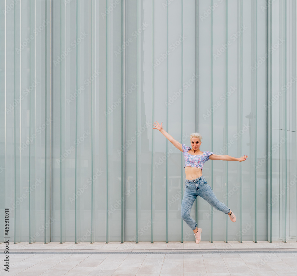 Young caucasian woman outdoor jumping celebrating success feeling free - advertising copyspace