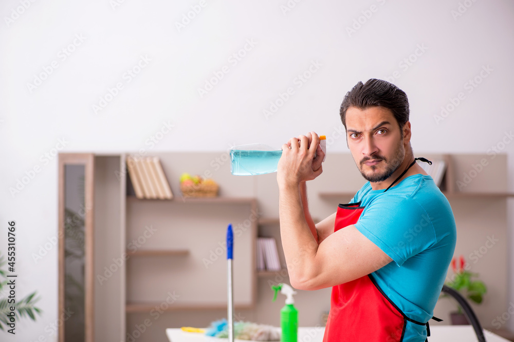 Young male contractor cleaning the house Young male contractor cleaning the house