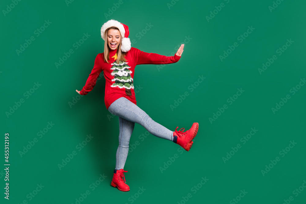 Full length body size view of attractive carefree cheerful girl dancing having fun December isolated over green color background Full length body size view of attractive carefree cheerful girl dancing having fun December isolated over green color background