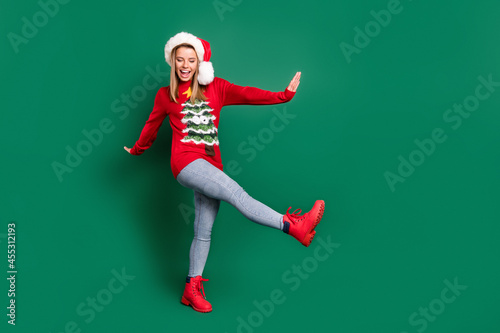 Full length body size view of attractive carefree cheerful girl dancing having fun December isolated over green color background