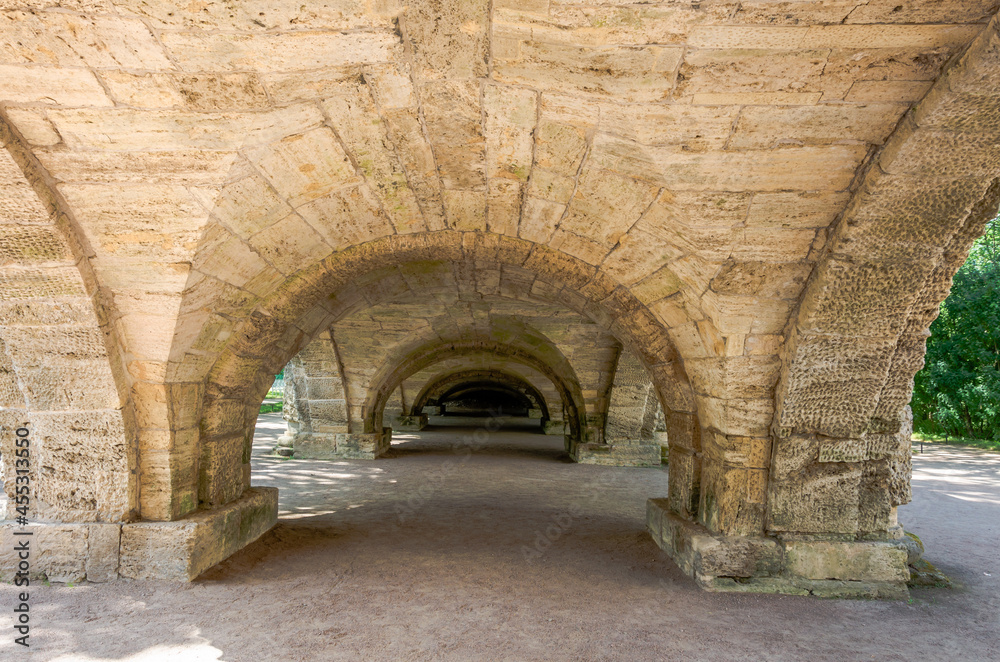 Under the arch of the stone bridge.