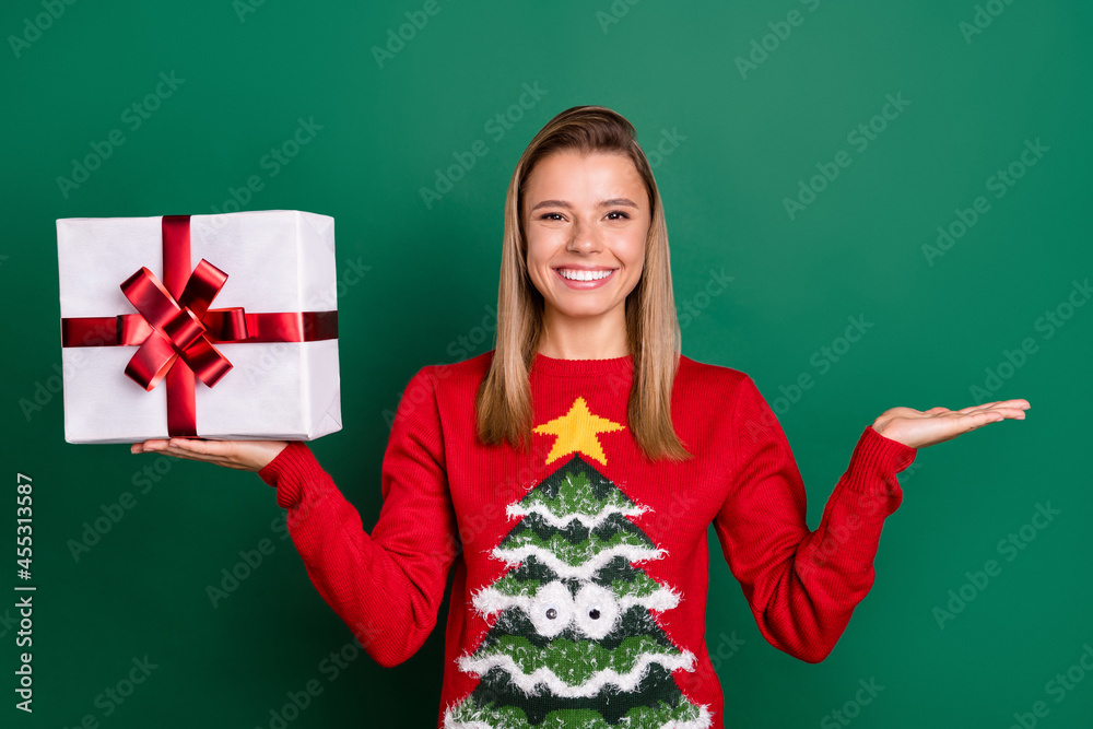 Portrait of attractive trendy cheerful girl holding in hands on palm copy space ad isolated over green color background Portrait of attractive trendy cheerful girl holding in hands on palm copy space ad isolated over green color background